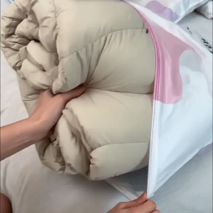 Hands loading bedding, sealing the bag, opening its valve and pressing out air
