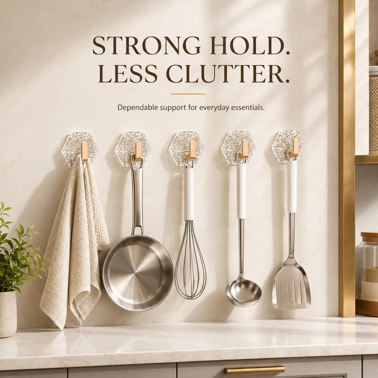 Clear L-shaped wall hooks holding kitchen tools and a towel