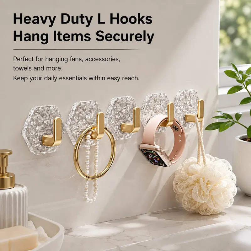 Clear L-shaped hooks holding bathroom accessories and a towel